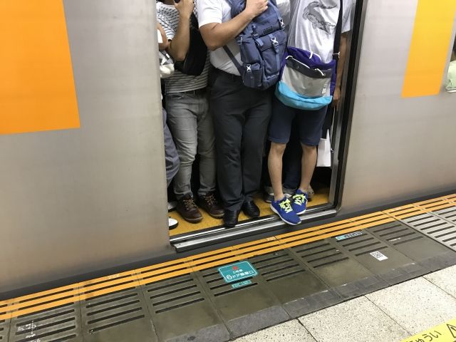満員電車で通勤する男性